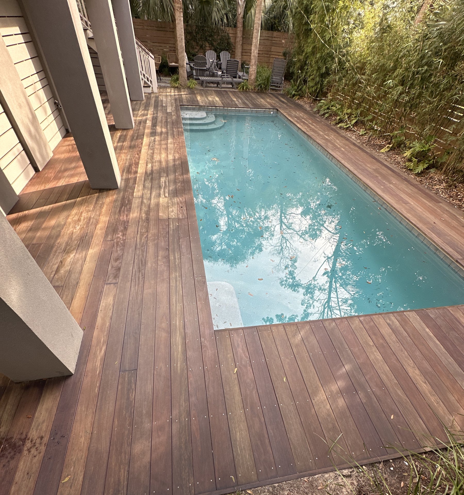Stained wood deck beside a pool